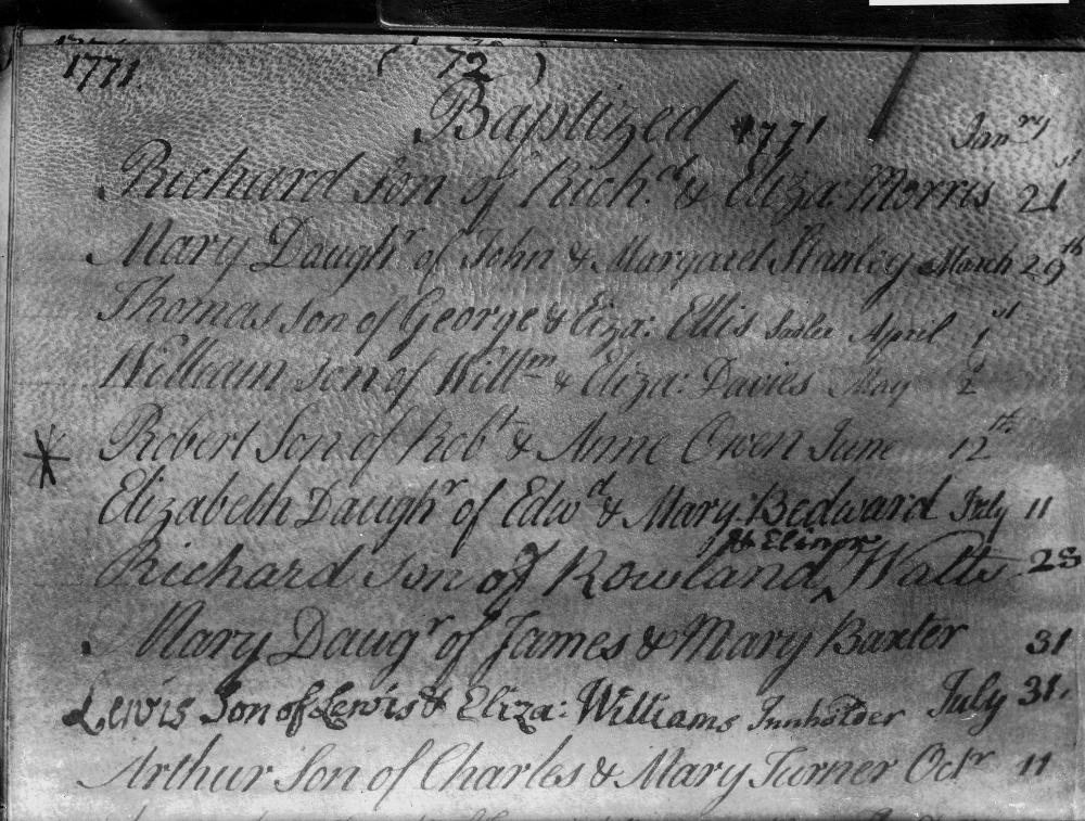 An open historical volume showing handwritten records inside an old ledger book.