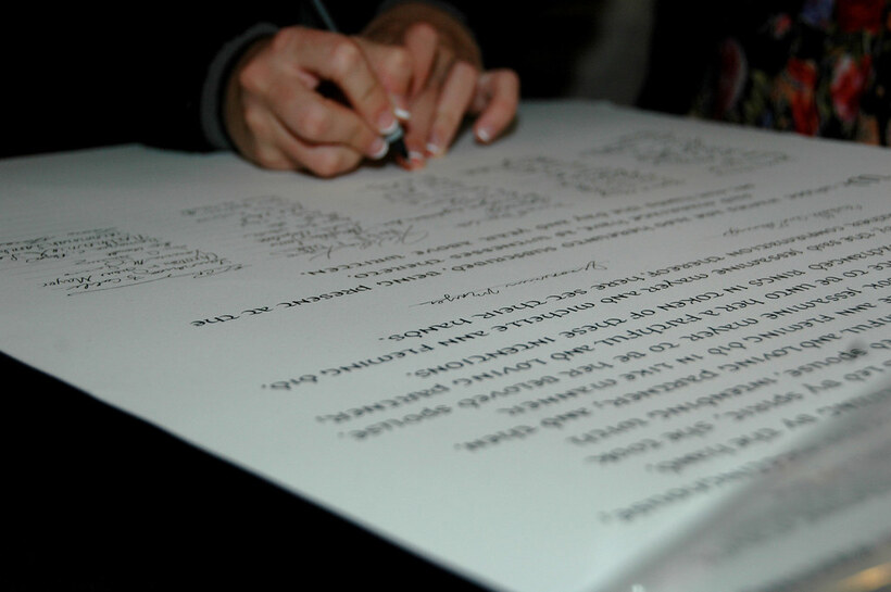 A historical Quaker marriage certificate featuring extensive columns of witness signatures.
