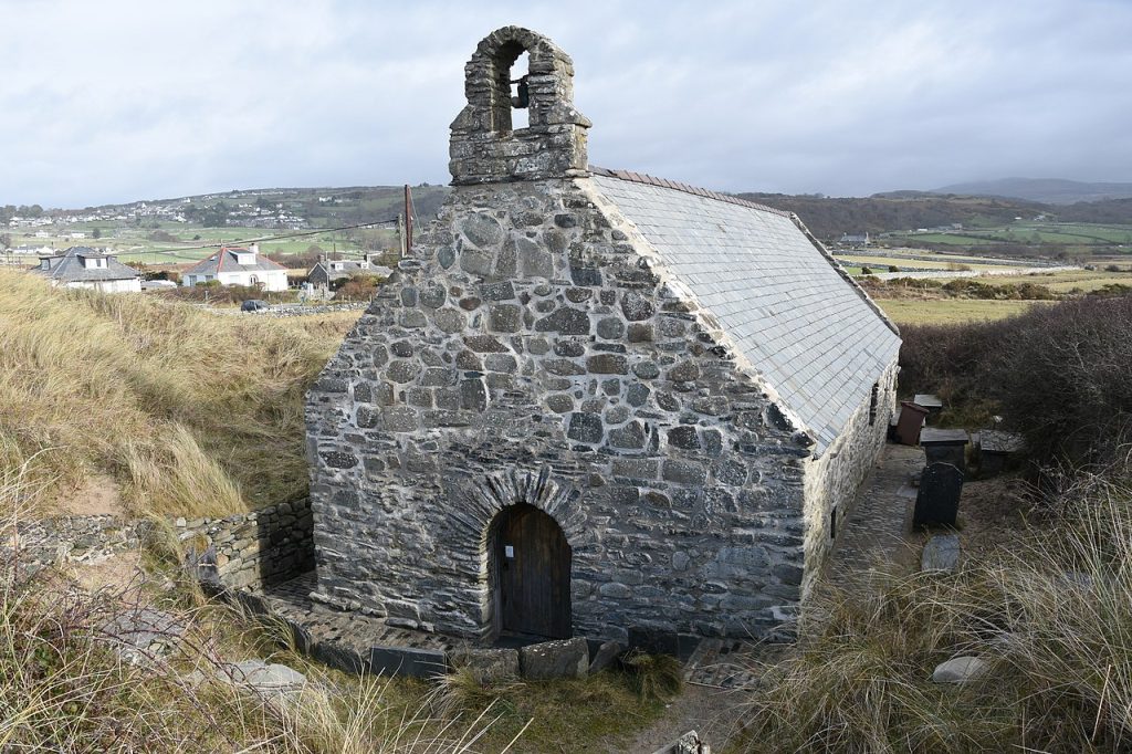 An old stone church in rural Wales representing the original homes of Welsh parish registers.