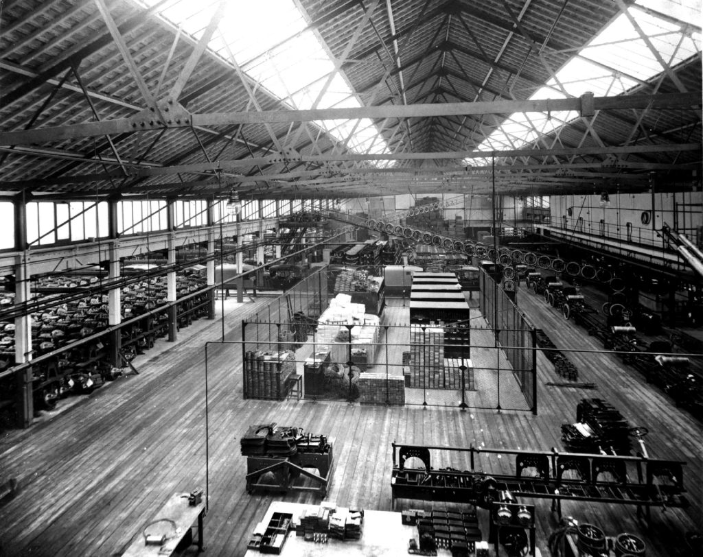 An interior view of a 1920s British factory representing the occupations found in the 1921 census.